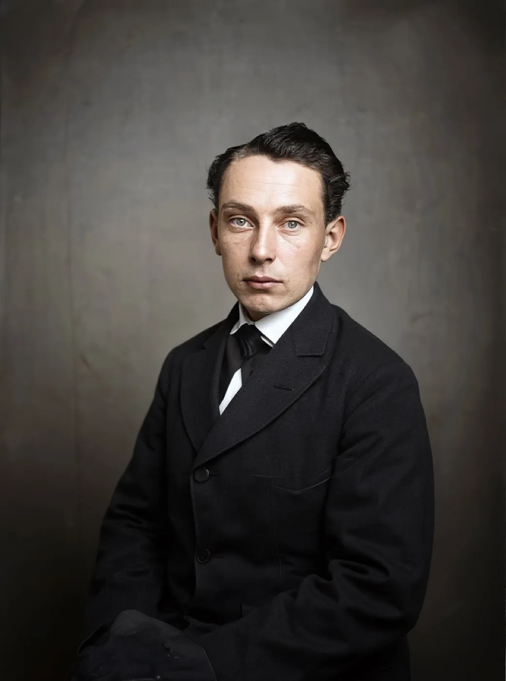 The low resolution scan restored, returned warmly colourised with the face rebuilt