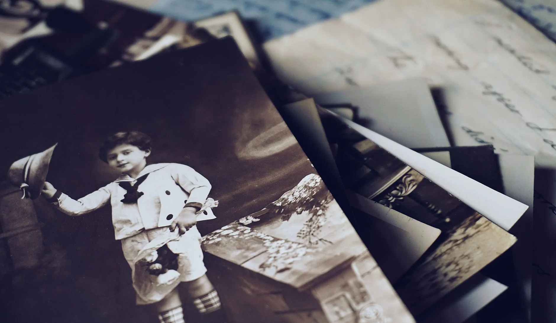Close-up of vintage colour photographs and letters showing an orange cast
