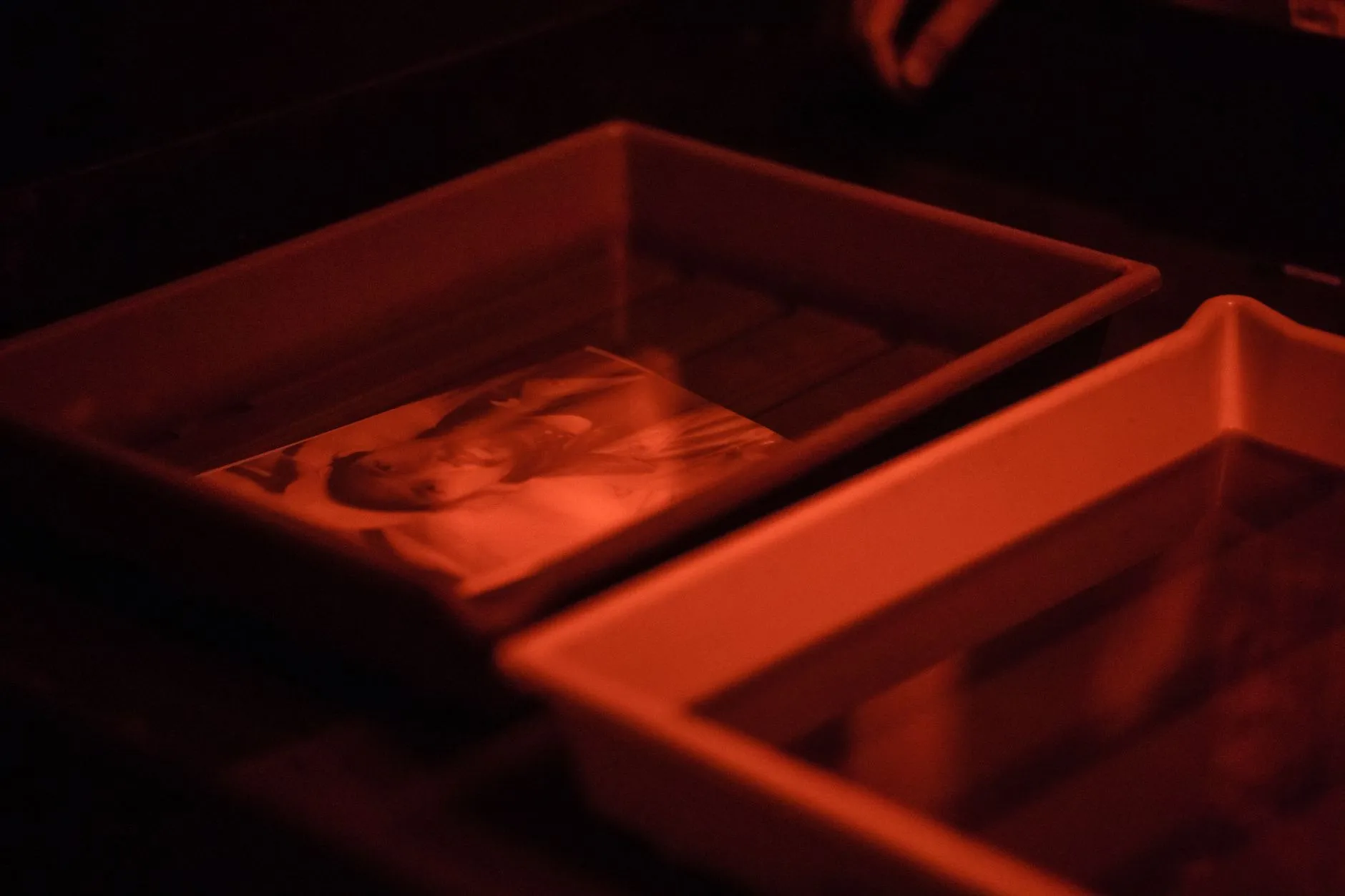 Photographic prints being handled in water during processing