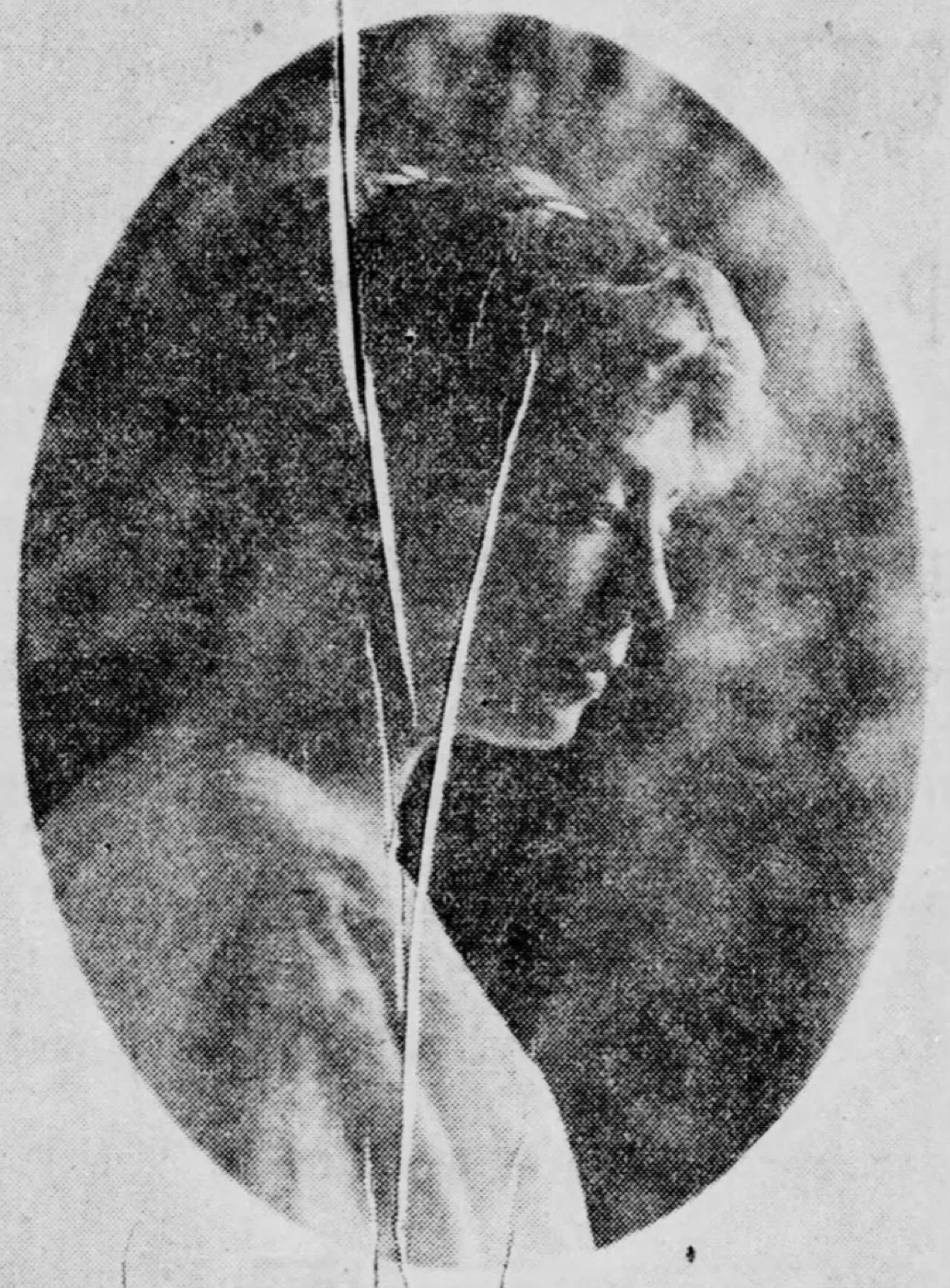 A screened 1914 newspaper portrait with a crack running down the face