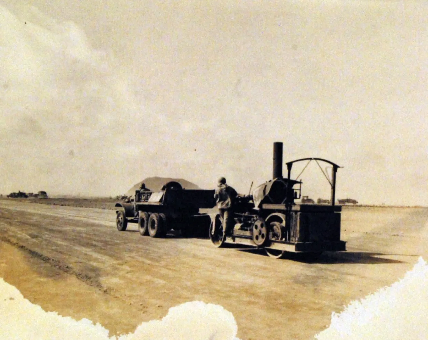 A 1940s record photograph with a hard tide line burned across its foot